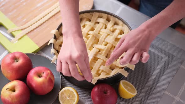 Apple Pie Preparation Series Woman Covering Baking Dish Full of Chopped Apples with Stripes of