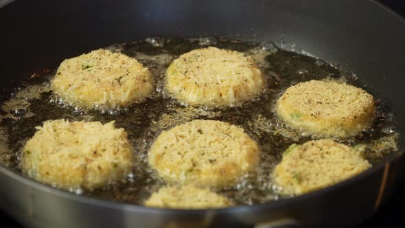 Close Up Shot of Cheese Snacks Fried Rotating in a Frying Pan