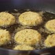 Close Up Shot of Cheese Snacks Fried Rotating in a Frying Pan - VideoHive Item for Sale