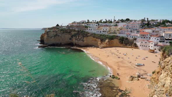 Beautiful View of the Portuguese Carvoeiro Beach in Summer with Clear Sea and Sunbathing Tourists