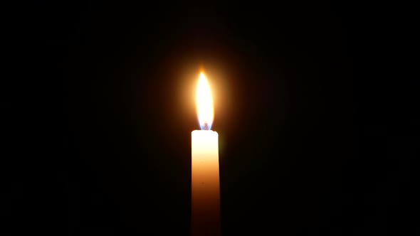 candle. flame night. burning candle in the dark. for prayer. White Candle Burns In The Dark