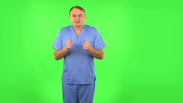 Medical Man Looking at Camera with Anticipation, Then Very Upset. Green Screen