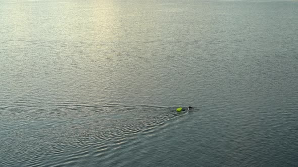 open water swimmer with a swim buoy on a calm lake