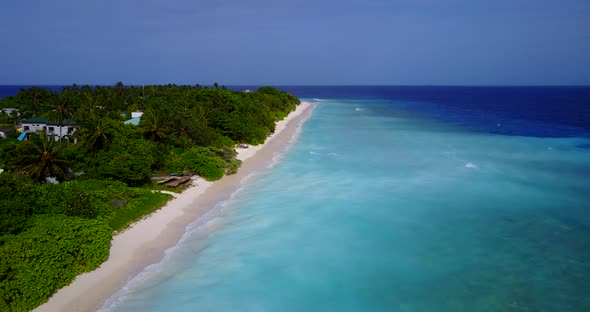 Tropical drone tourism shot of a white sand paradise beach and blue sea background 