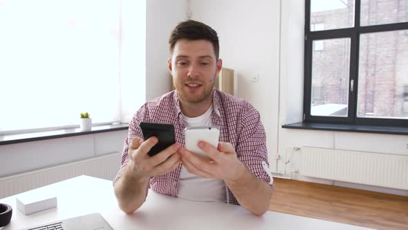 Male Blogger with Smartphone Videoblogging at Home 