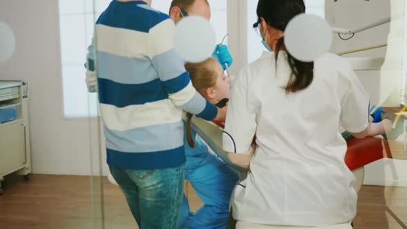 Dentistry Doctors Cleaning Teeth of Child Treating Dental Problems