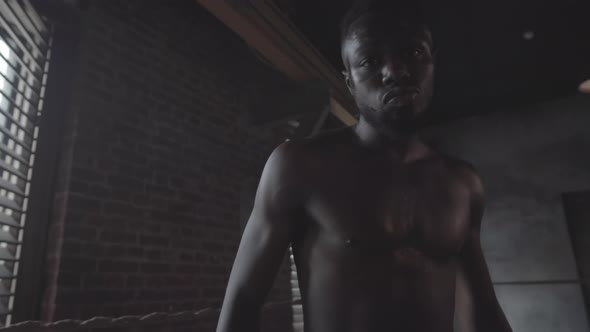 Young Black Fighter Shadow Boxing then Looking at Camera