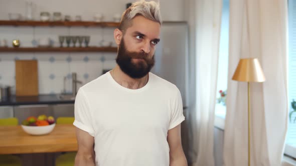 Hipster Weak Guy Doing Fitness Training with Dumbbells at Home