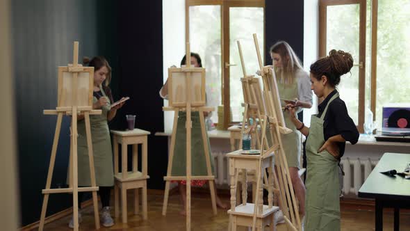 Beautiful Female Students Painting at Art Lesson in Art Studio