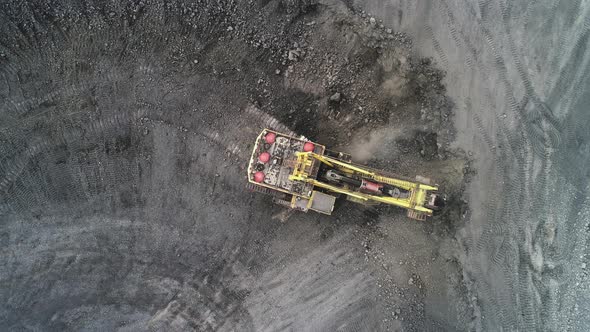 Cable Excavator Loads Overburden From the Body of a Mining Truck.