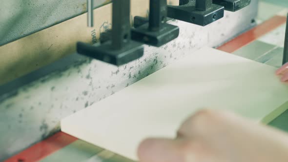 Factory Mechanism Is Punching Holes in Paper