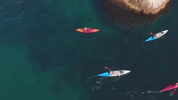 Aerial Shot Group of Kayakers Paddling Down on Mountain River on Kayaks on Summer Day