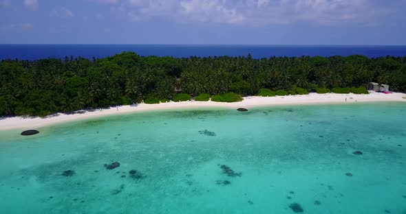 Beautiful flying travel shot of a white paradise beach and aqua turquoise water background in 4K