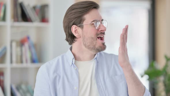 Portrait of Sleepy Man in Glasses Yawning