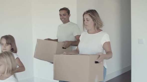 Family Couple and Two Kids Moving Into New Apartment