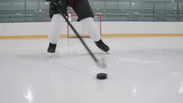 Male Hockey Player Skating With Puck