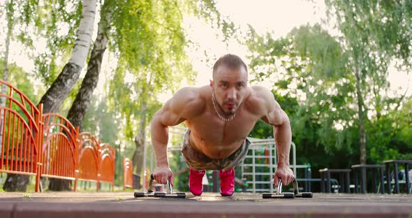 Man Performing Pushups Exercises in Park