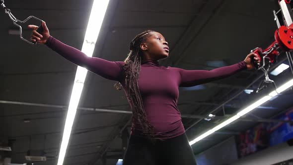 Sports Training  Black Woman Training Her Hands with Pulling the Holders Attached To the Weight