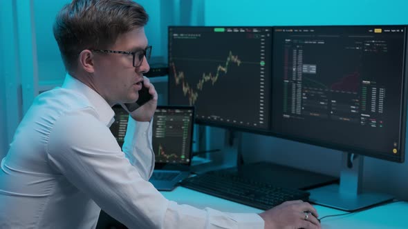 Financial Day Trader Working on a Computer with Multi-Monitor Workstation with Real-Time Stocks