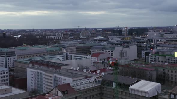 AERIAL: Slowly Flying Over Center of Berlin Germany with Construction Site Cranes at Sunset  alt
