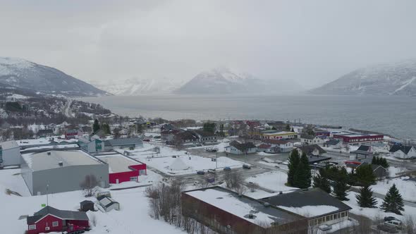 Kåfjord town centre and harbour in Olderdalen, Norway. Fjord and mountains in the background. Overca