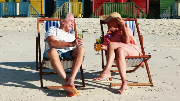 Senior couple interacting with each other while having cocktail