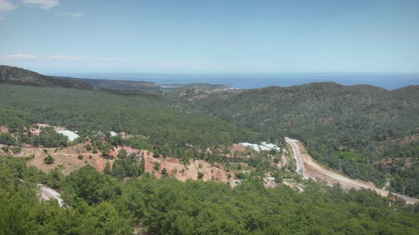 Beautiful aerial view of mountain valley with sea on background.