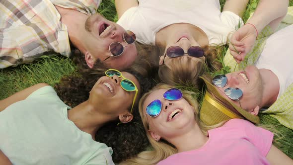 People Lying on Grass, Enjoying Life and Laughing, Sky Reflection in Sunglasses