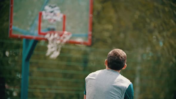 A Man Throwing the Ball in the Basketball Hoop and Misses