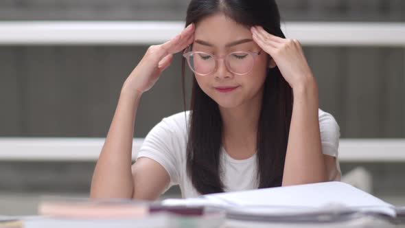Young undergraduate girl do homework, read textbook, study hard for knowledge and education