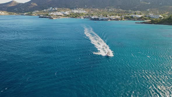 Aerial View of a Motor Boat Towing a Water Skier. Elounda, Crete, Greece