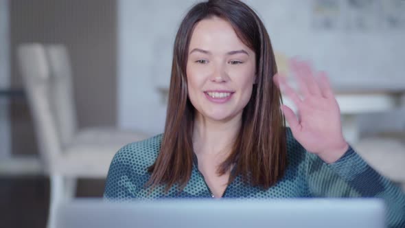 Positive Beautiful Caucasian Woman Waving Goodbye To Online Trainer and Closing Laptop. Portrait of