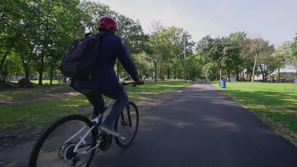 Young Commuter Riding a Bicycle