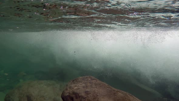 Underwater Rocks and Air Bubbles at Stream