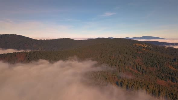 Aerial View of Clouds Above Green Forest Mountains Nature