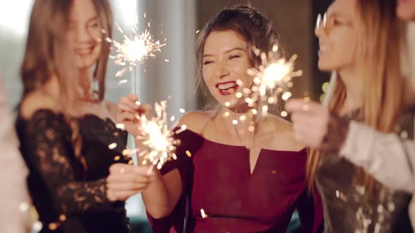 Asian Girl and Group Young College Student Friends Lit Light Sparkler in Hand Fireworks Sing and