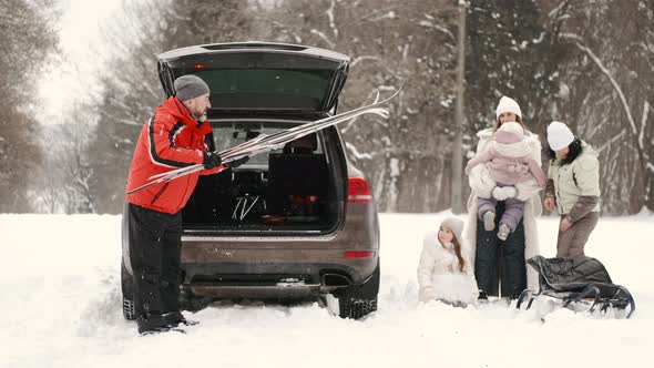 Family in Winter Forest with Kids on Weekend