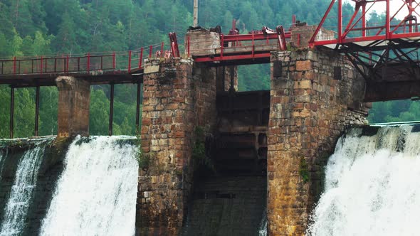 Water Dam in the Middle of the Forest - Water Falls Down Under the Bridge