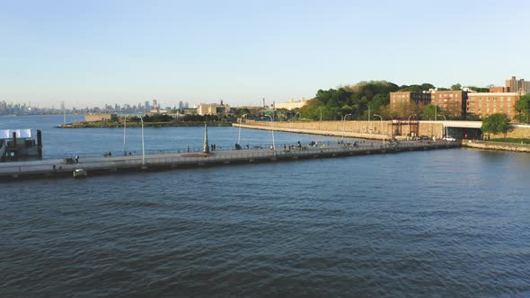 Aerial Shot of a Pier Next to an Urban Neighborhood with New York Skyline (Bay Ridge, Brooklyn, NY)