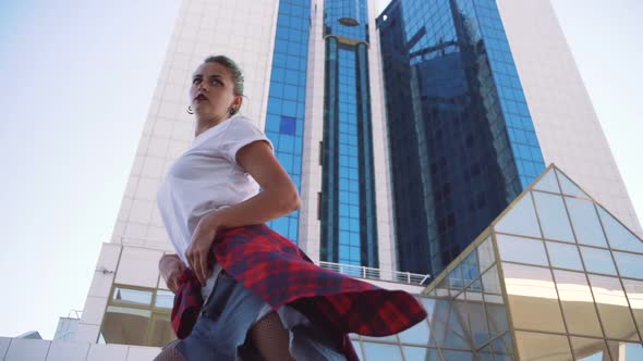 Attractive Young Woman in a Stylish Look and Green Hair Dancing Freely on Urban Background Slow