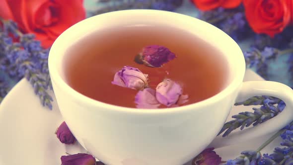 Provencal style composition: white cap of  tea with fragrant rose buds, fresh rose flowers 