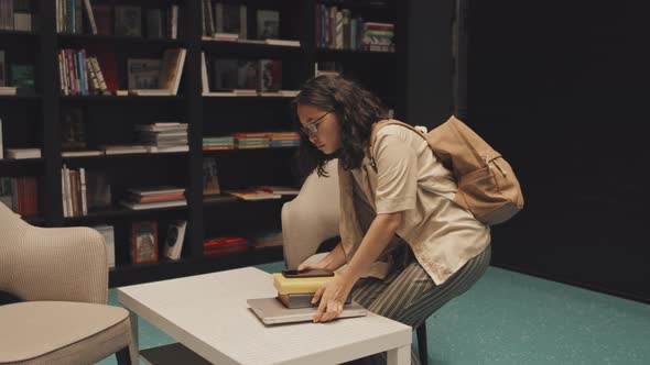 Female Asian Student Studying at Library