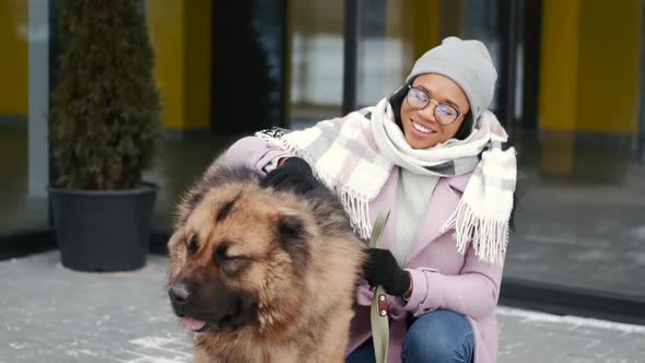 Woman Walking Cute Dog Outdoors on Winter Day