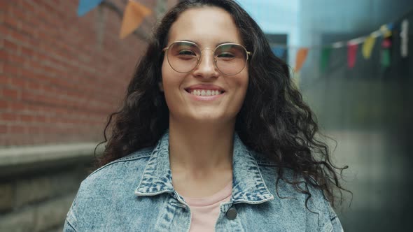 Portrait of Happy Asian Student in Glasses Smiling and Laughing Having Fun Outdoors in City Street