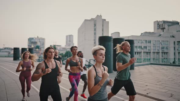 Men and Women Take Part in a Running Marathon Multiracial Group