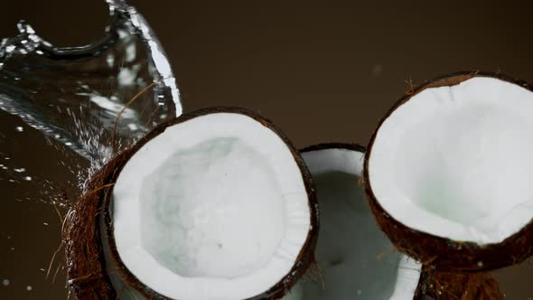 Super Slow Motion Shot of Flying Fresh Coconuts and Water Side Splash at 1000Fps.