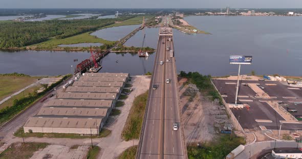 Aerial of cars on traveling over the Mississippi river on the Horace Wilkinson Bridge