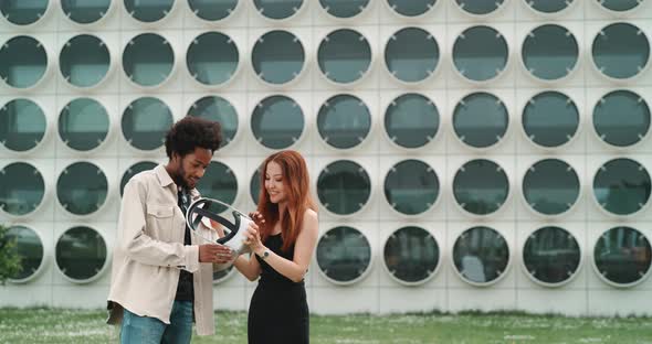 A girl and a guy experimenting virtual reality in the city center