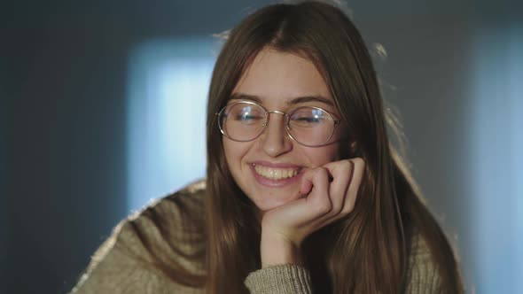 Portrait of Cute Student in Glasses Leans on Hand and Dreams Inside