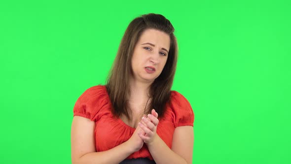 Portrait of Cute Girl Clapping Her Hands with Dissatisfaction. Green Screen